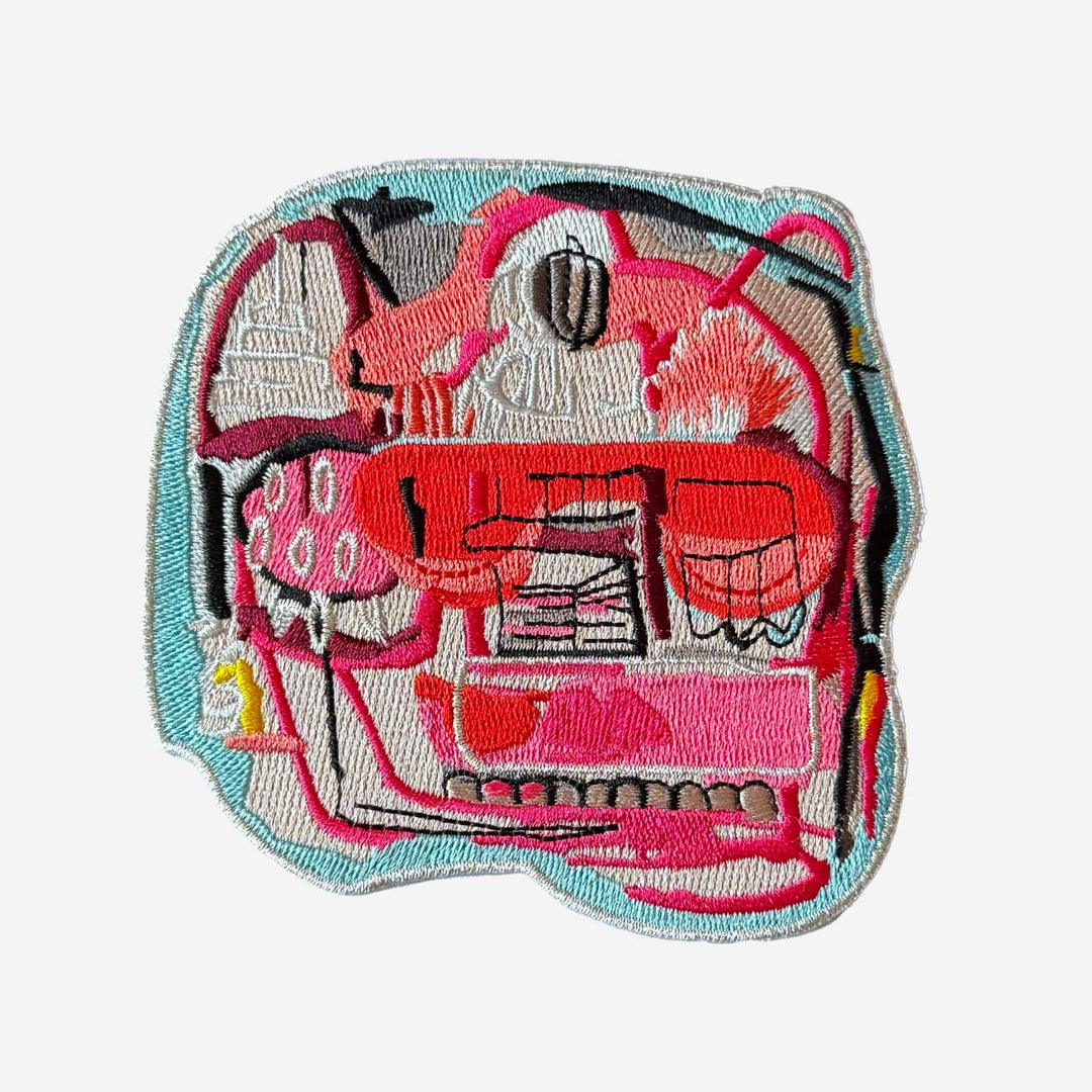 Embroidered patch with a pink flamingo design on a white background