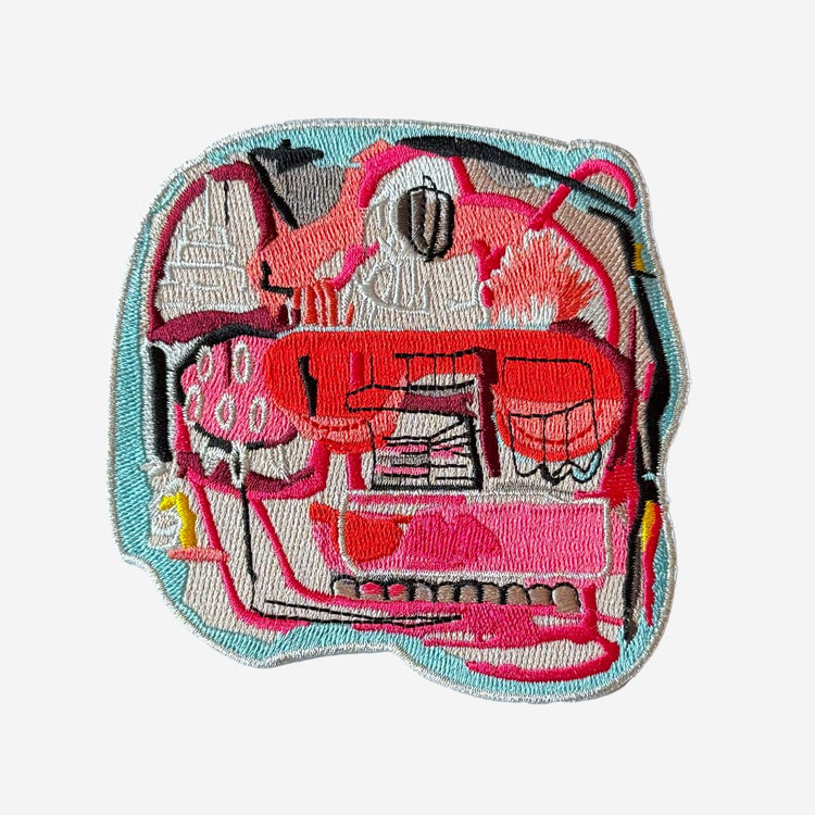 Embroidered patch with a pink flamingo design on a white background