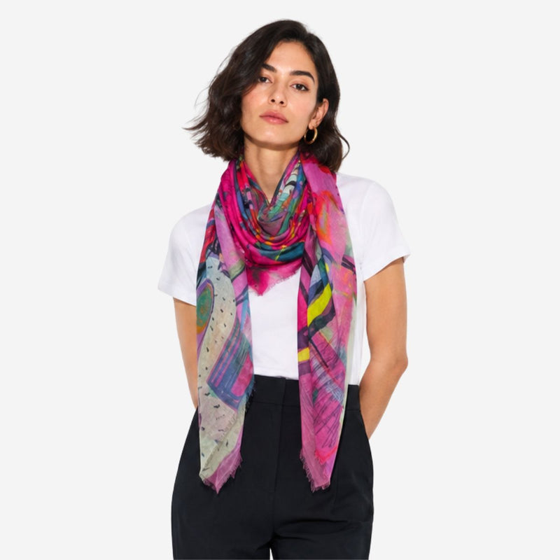 Bloom Silk Scarf by Isabelle Gougenheim worn loosely around the neck, showing its pink and multicolor abstract design.