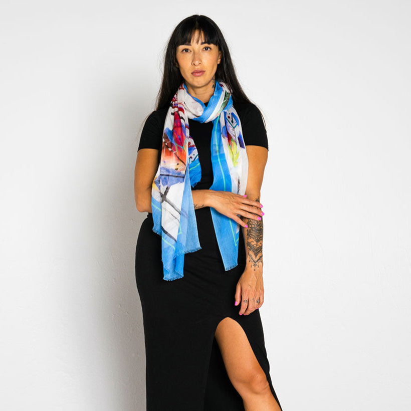 Woman wearing a colorful scarf and black outfit on a white background