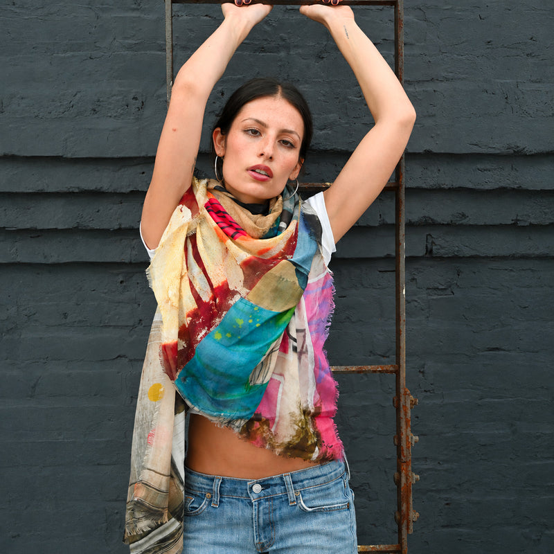 Model wearing the Moments Silk Scarf by Isabelle Gougenheim loosely wrapped around the neck, showing its colorful abstract design.