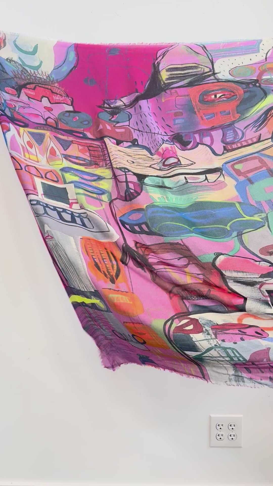 Bloom Silk Scarf by Isabelle Gougenheim being unfolded to show its colorful abstract design.