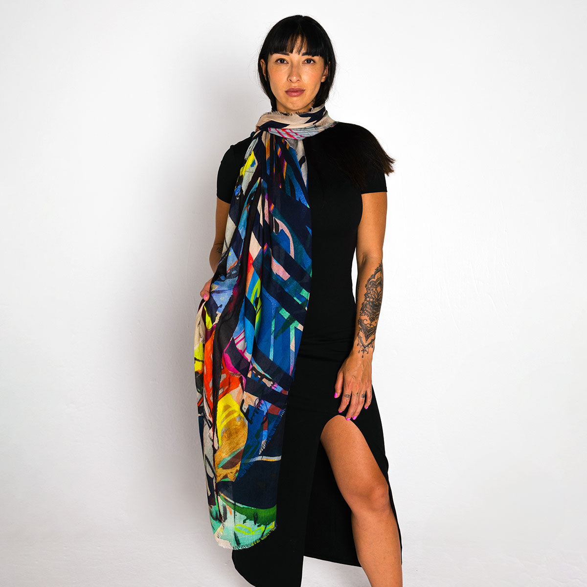 Woman wearing a colorful scarf with a black background
